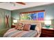 Comfortable bedroom featuring a ceiling fan, bedside tables, and a window offering natural light and outdoor view at 3220 Pawnee Dr, Las Vegas, NV 89169