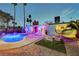 Backyard showcasing a pool, patio dining set, and a lush, tropical setting at 3220 Pawnee Dr, Las Vegas, NV 89169