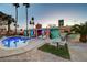 Backyard with a pool, outdoor dining, lounge area, and desert landscape at 3220 Pawnee Dr, Las Vegas, NV 89169