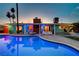 Inviting pool area with modern lounge furniture and vibrant outdoor lighting at 3220 Pawnee Dr, Las Vegas, NV 89169