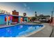 Sparkling pool with lounge chairs and lush tropical landscaping in the backyard oasis at 3220 Pawnee Dr, Las Vegas, NV 89169