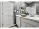 Well-lit bathroom with a double vanity, door and tasteful decor at 3903 Henny Ave, Las Vegas, NV 89141