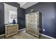 Bedroom with stylish furnishings, mirrored dresser, bedside table and a large window at 3903 Henny Ave, Las Vegas, NV 89141