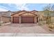 Charming home showcasing a well-manicured lawn and an inviting two-car garage at 3903 Henny Ave, Las Vegas, NV 89141