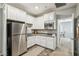 Well-equipped kitchen with white cabinetry, modern appliances, and ample counter space, adjacent to the living area at 3903 Henny Ave, Las Vegas, NV 89141