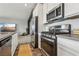 Modern kitchen with stainless steel appliances and a view into the living room at 3903 Henny Ave, Las Vegas, NV 89141
