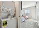 Stacked washer and dryer near a bedroom with twin beds at 3903 Henny Ave, Las Vegas, NV 89141