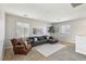 Bright living room featuring a plush sofa, accent chair, and large windows for natural light at 3903 Henny Ave, Las Vegas, NV 89141