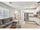 Open-concept living area connecting to the kitchen, featuring a comfortable sofa and stainless steel appliances at 3903 Henny Ave, Las Vegas, NV 89141