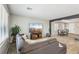 Spacious living area seamlessly connects to the dining room, featuring a large sectional sofa and neutral color palette at 3903 Henny Ave, Las Vegas, NV 89141