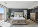 Well-lit main bedroom with a decorative bed frame, stylish bedside tables, and neutral decor at 3903 Henny Ave, Las Vegas, NV 89141