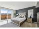 Main bedroom with a sliding glass door leading to a balcony and a neutral color palette at 3903 Henny Ave, Las Vegas, NV 89141