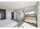 Spacious main bedroom with modern furnishings, and an access door to the outdoor balcony at 3903 Henny Ave, Las Vegas, NV 89141