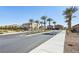 A tree-lined street features well-maintained homes and landscaping under a clear blue sky, showcasing a desirable neighborhood at 3903 Henny Ave, Las Vegas, NV 89141