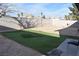Large backyard with partial artificial turf installation; concrete block perimeter wall at 4120 E Cincinnati Ave, Las Vegas, NV 89104