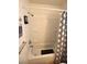 Bathroom features a shower-tub combination with white shower surround and a decorative shower curtain at 4120 E Cincinnati Ave, Las Vegas, NV 89104