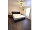 Bright bedroom with laminate flooring, ceiling fan, and large windows with white curtains at 4120 E Cincinnati Ave, Las Vegas, NV 89104
