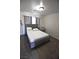 Bedroom with a gray studded headboard and gray wood flooring at 4120 E Cincinnati Ave, Las Vegas, NV 89104