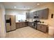 Bright kitchen featuring stainless steel appliances, tile floor and gray cabinets at 4120 E Cincinnati Ave, Las Vegas, NV 89104