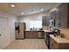 Bright kitchen featuring stainless steel appliances, tile floor and gray cabinets at 4120 E Cincinnati Ave, Las Vegas, NV 89104