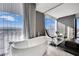 Luxurious bathroom showcasing a freestanding tub, modern fixtures, and expansive windows with city views at 4381 W Flamingo Rd # 1901, Las Vegas, NV 89103