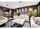 Modern living area featuring a large TV, unique wall art, and stylish, neutral-toned furniture at 4381 W Flamingo Rd # 1901, Las Vegas, NV 89103