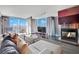 Cozy living room with a fireplace, comfortable seating, and a picturesque view from the expansive windows at 4381 W Flamingo Rd # 1901, Las Vegas, NV 89103