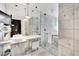 Luxurious bathroom with double sinks, marble finishes, glass-enclosed shower, and modern fixtures at 4381 W Flamingo Rd # 1903, Las Vegas, NV 89103