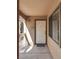 Front door of unit 207 with covered porch, window, and exterior light at 5138 S Jones Blvd # 207, Las Vegas, NV 89118