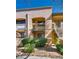 Exterior view of a condo with balconies, stairs, and well-maintained landscaping at 5138 S Jones Blvd # 207, Las Vegas, NV 89118