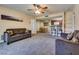 Spacious living room with neutral carpet, ceiling fan, and open view to dining and kitchen at 5138 S Jones Blvd # 207, Las Vegas, NV 89118