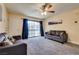 Comfortable living room with plush carpeting, ceiling fan, and sliding glass doors at 5138 S Jones Blvd # 207, Las Vegas, NV 89118