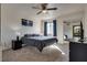 Spacious bedroom with a ceiling fan, plush carpet, and mirrored closet doors at 5166 S Jones Blvd # 202, Las Vegas, NV 89118