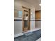 Hallway leading to the elevator with neutral tilework and visible call buttons at 5166 S Jones Blvd # 202, Las Vegas, NV 89118
