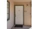 Front door featuring unit number 202 with green trim, a welcome mat, and an outdoor light fixture at 5166 S Jones Blvd # 202, Las Vegas, NV 89118