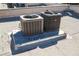 Two air conditioning units on the roof with the sun shining on them at 5166 S Jones Blvd # 202, Las Vegas, NV 89118