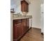 A well-maintained kitchen with dark wood cabinets, updated counters, and appliances at 5166 S Jones Blvd # 202, Las Vegas, NV 89118