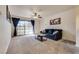 Spacious living room with a ceiling fan, carpeting, and sliding glass doors at 5166 S Jones Blvd # 202, Las Vegas, NV 89118
