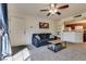 Cozy living room with carpeted floors, a ceiling fan, and a view into the kitchen at 5166 S Jones Blvd # 202, Las Vegas, NV 89118