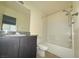 Bathroom showcasing a vanity with a granite countertop and shower-tub combo at 5183 Silica Chalk Ave, Las Vegas, NV 89115
