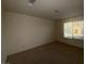 A carpeted bedroom featuring natural light from a window with blinds at 5183 Silica Chalk Ave, Las Vegas, NV 89115