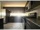 Stylish kitchen offering dark cabinetry, stainless steel appliances, and granite counters at 5183 Silica Chalk Ave, Las Vegas, NV 89115