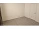 Carpeted bedroom with white walls, closet door, and natural light from a window at 520 Arrowhead Trl # 1411, Henderson, NV 89015