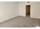 Bright bedroom featuring neutral carpet, white walls, and a doorway leading to an adjacent space at 520 Arrowhead Trl # 1411, Henderson, NV 89015