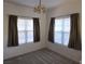 Cozy bedroom with plush carpet, natural light from two windows with curtains, and a decorative light fixture at 520 Arrowhead Trl # 1411, Henderson, NV 89015