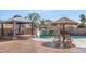 Beautiful backyard with a pool, gazebo, tiki umbrella, and comfortable lounge chairs at 6136 Stanton Summit Dr, North Las Vegas, NV 89081