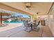 Stunning backyard with a pool, outdoor dining area, and a tiki hut for relaxation at 6136 Stanton Summit Dr, North Las Vegas, NV 89081