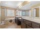Tiled bathroom features a shower with glass enclosure and a large mirror above the vanities at 6136 Stanton Summit Dr, North Las Vegas, NV 89081