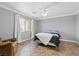 Spacious bedroom with ceiling fan, tiled floor, and large window with natural light at 6136 Stanton Summit Dr, North Las Vegas, NV 89081