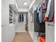 Walk-in closet with built-in shelving and hanging rods for ample storage at 6136 Stanton Summit Dr, North Las Vegas, NV 89081